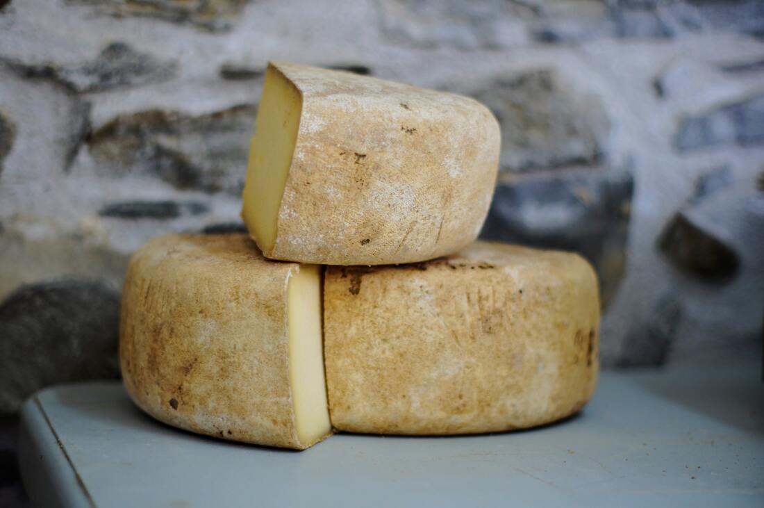 Pile of three large wedges of homemade cheese